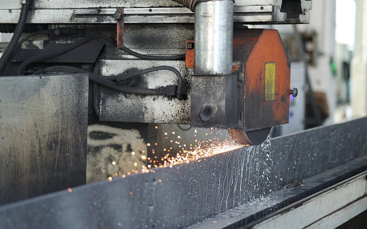 A grinding wheel finishing the working surface of a long tool